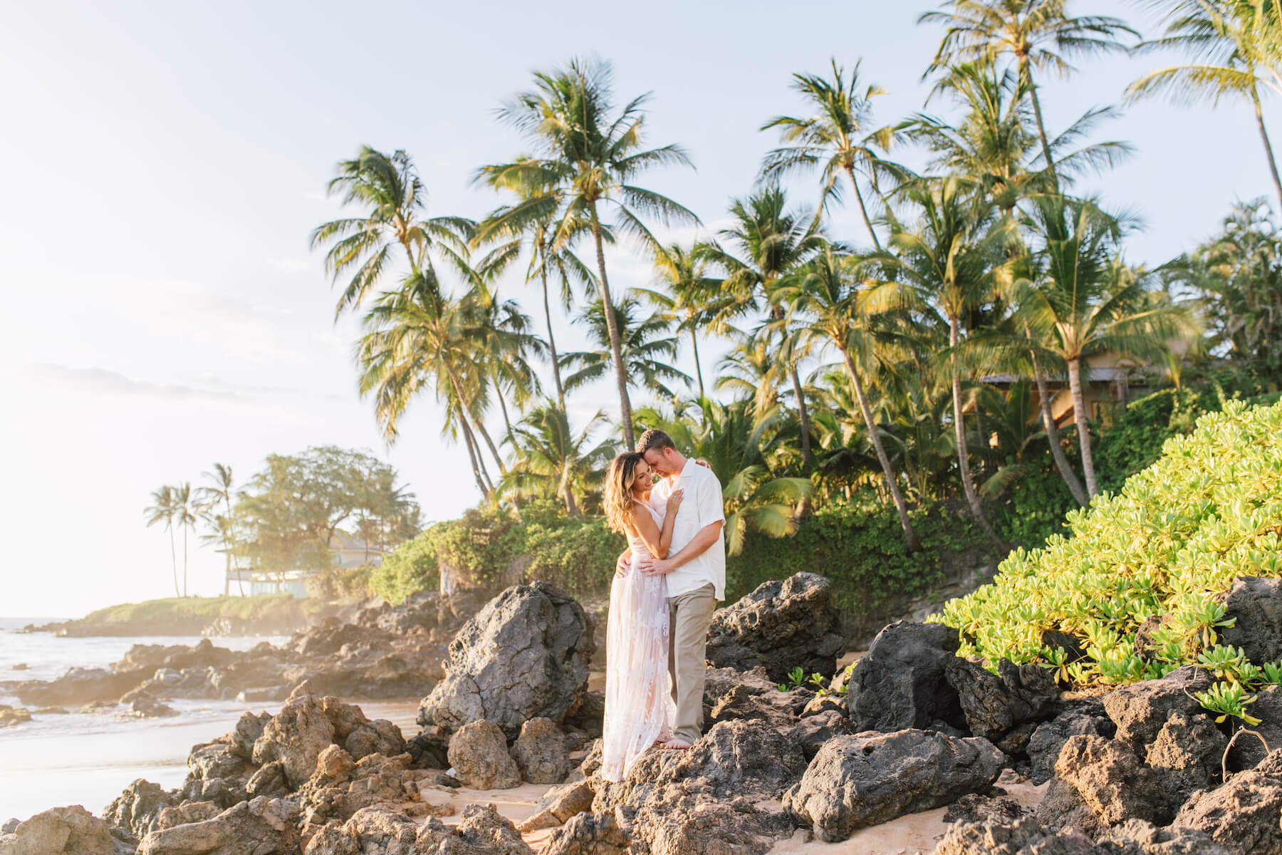 Couple hugging each other on the beach in Maui, Hawaii