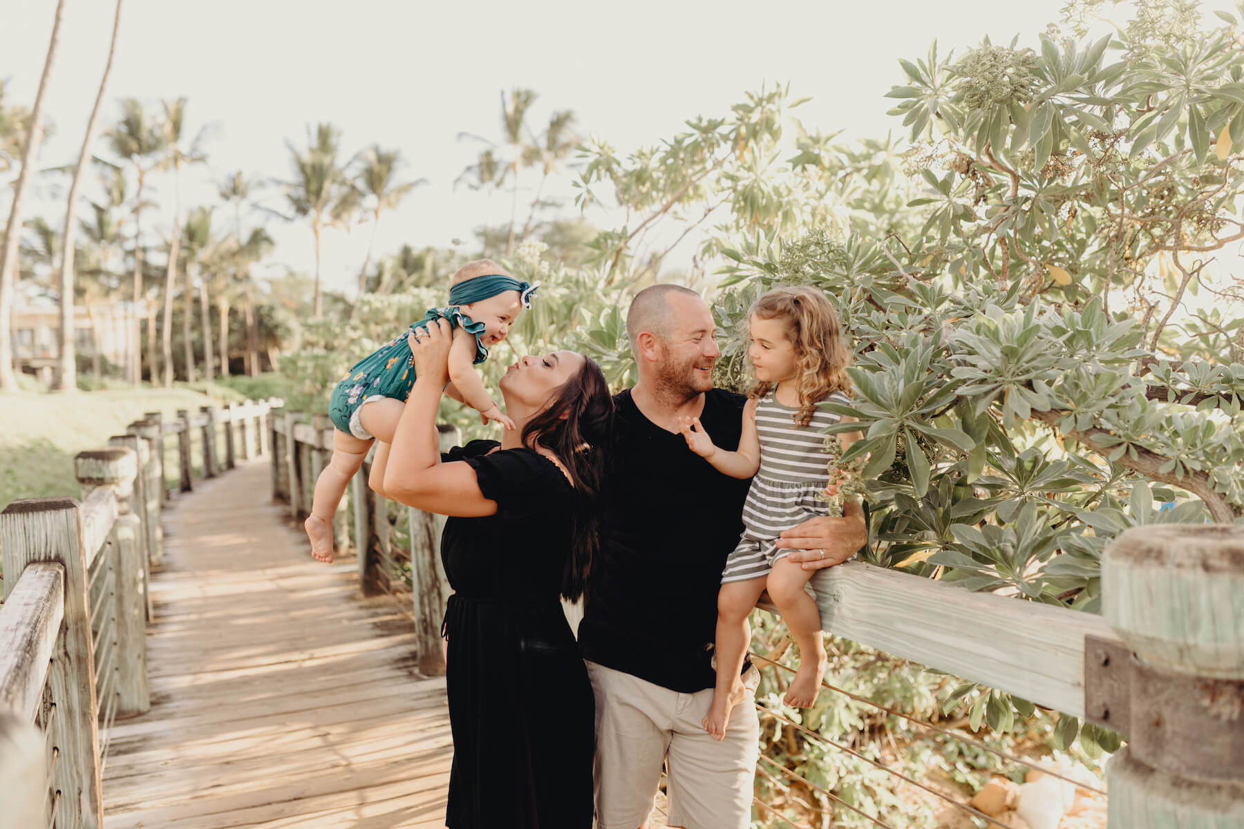 family of four, mom is holding the baby and having fun in Maui, Hawaii