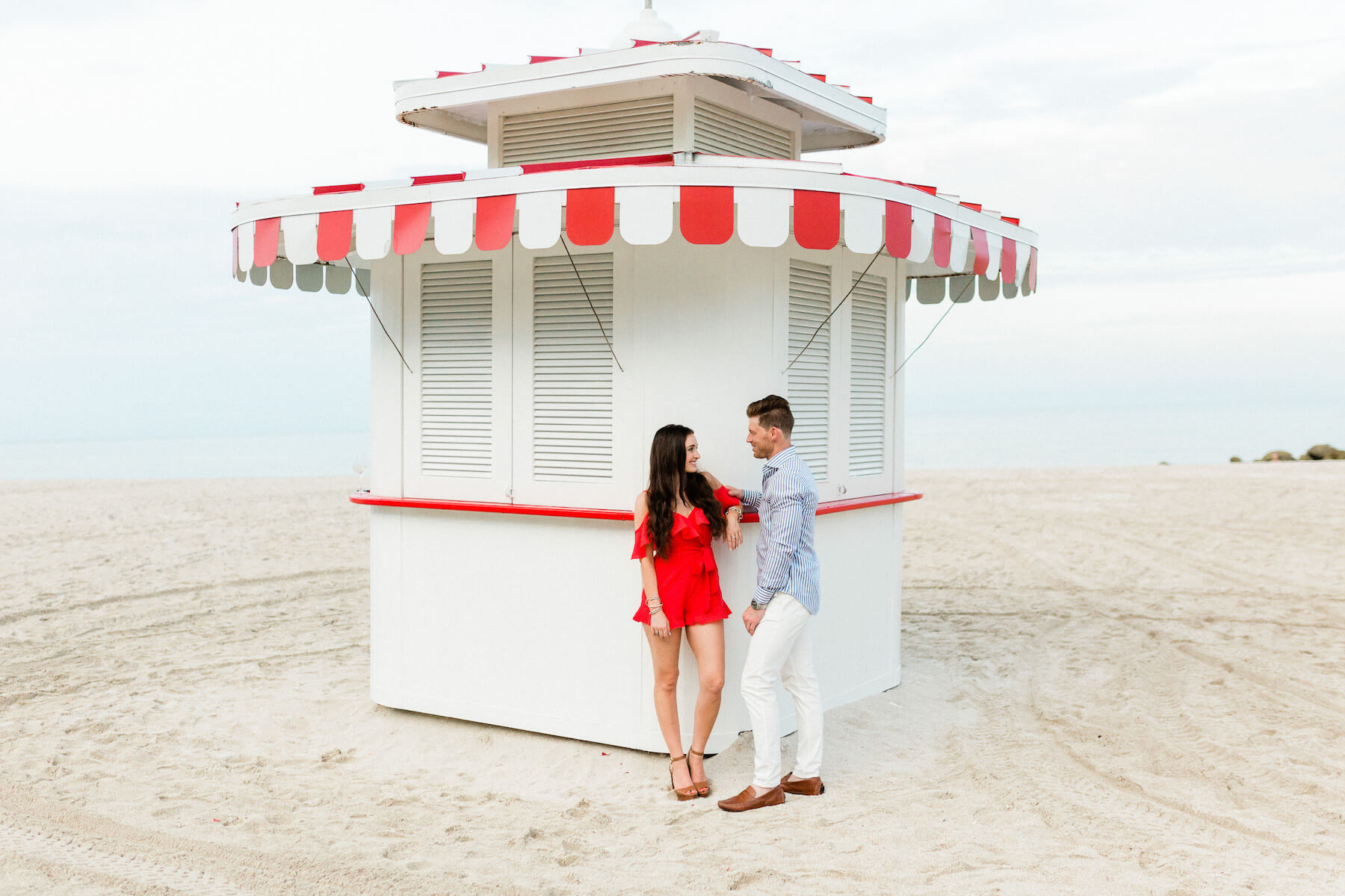 couple standing in front of concession stand on the beach in Miami, Florida