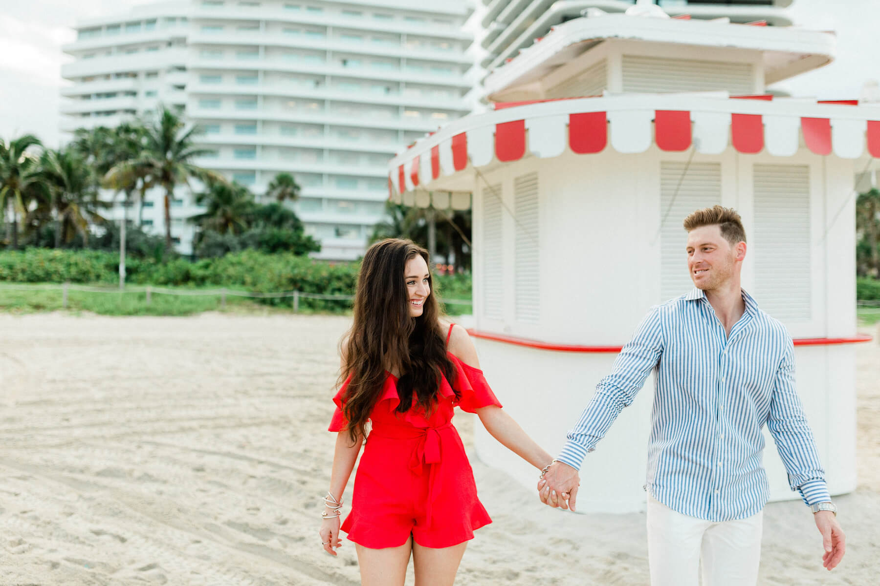 Couple standing in front of a concession stand on the beach in Miami, Florida