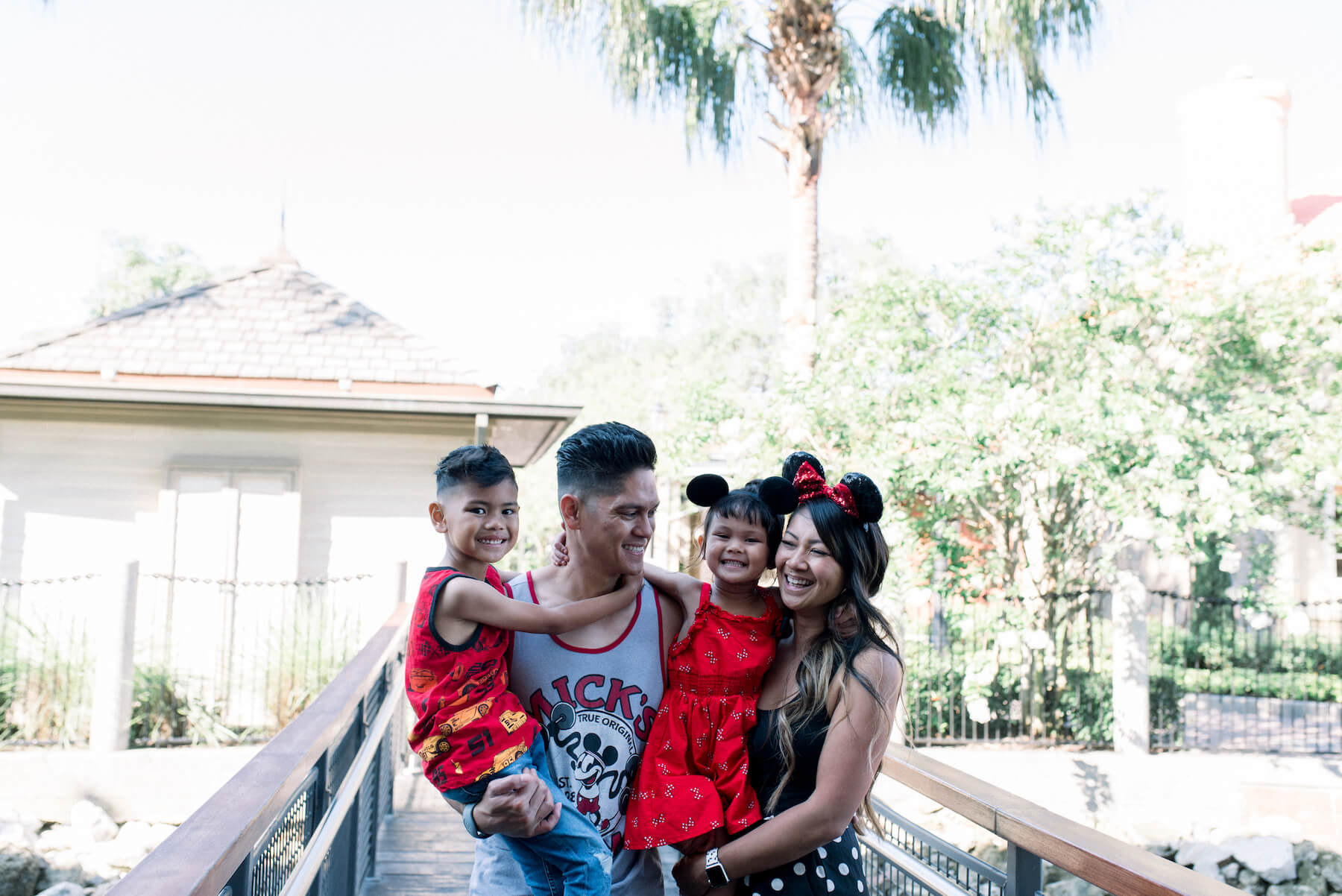 family laughing and wearing Mickey mouse ears in Disney Orlando, Florida