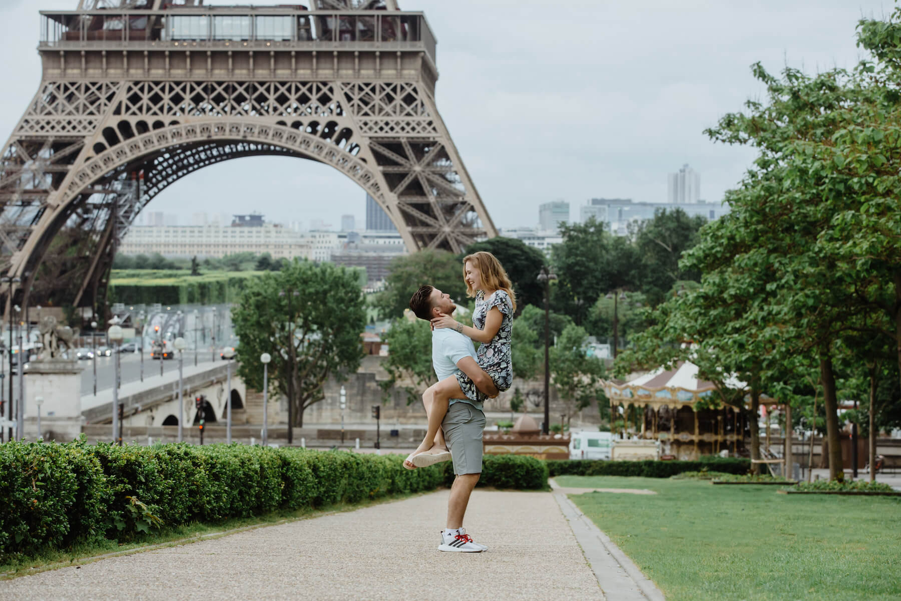 couple in front of the Eiffel Tower having fun in Paris, France