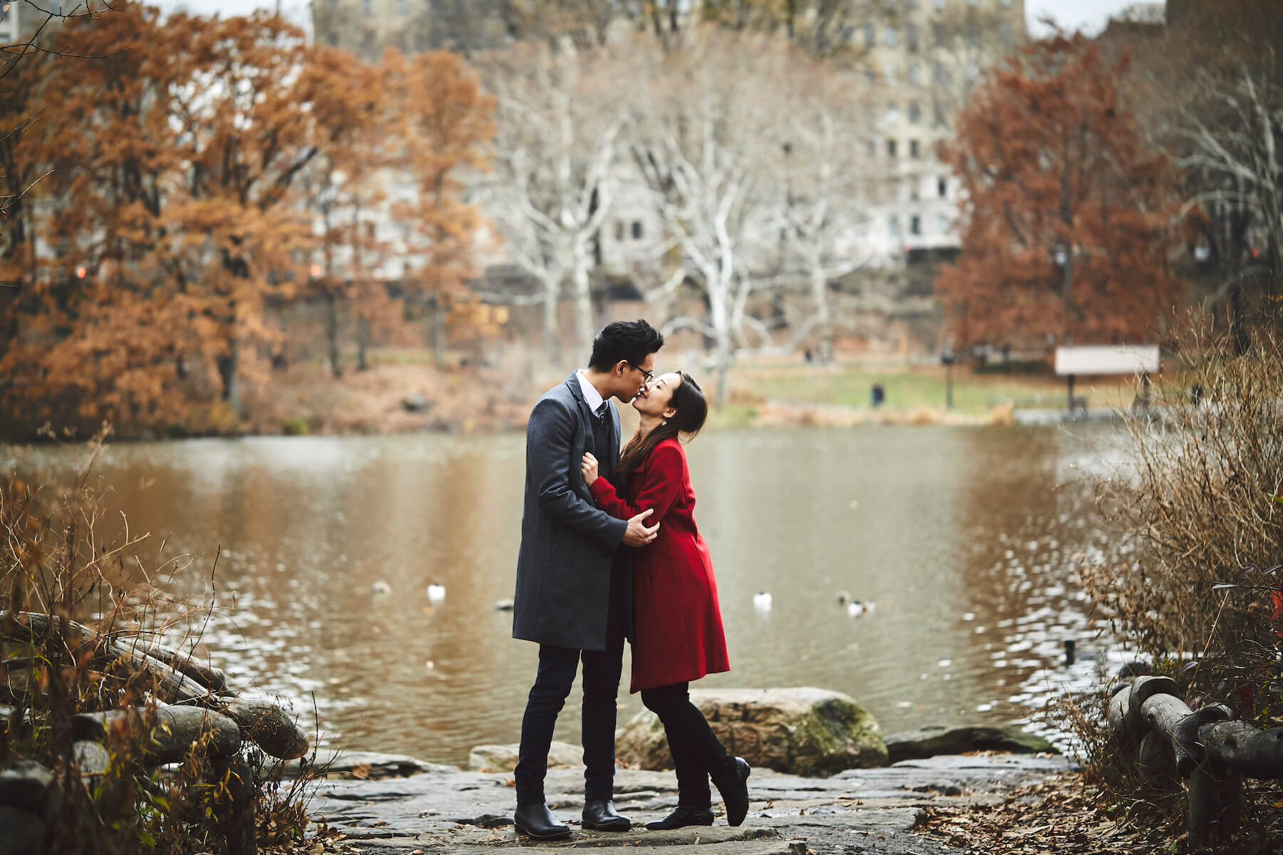 Couple holding each other and kissing in central park, New York City, New York