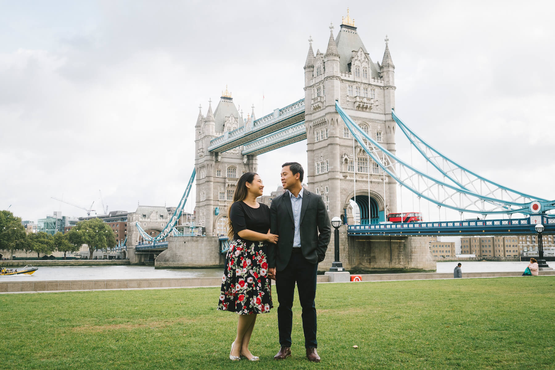 Couple in front of the London Bridge holding hands, London, England