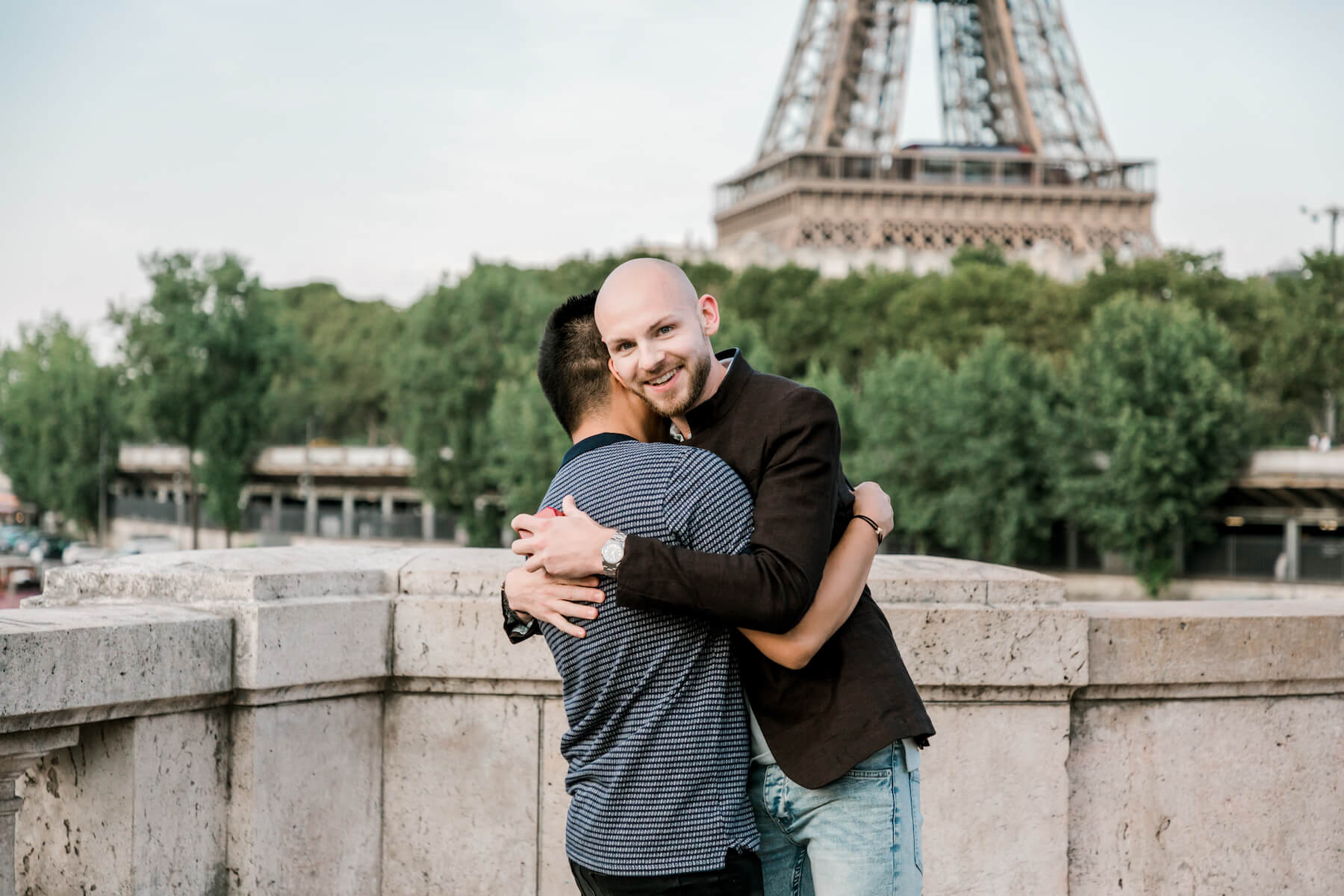 A couple hugging each other after the wedding proposal in Paris, France