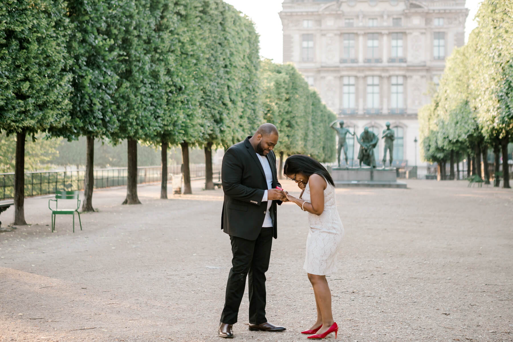 A woman excited and happy after being proposed on the Louvre grounds in Paris, France