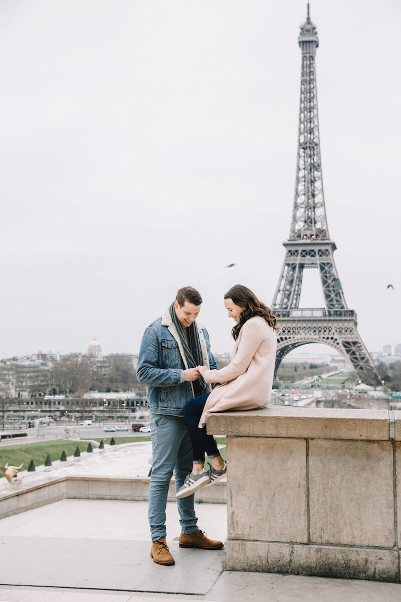 A man and woman looking at her ring after the proposal in Eiffel tower in Paris, France