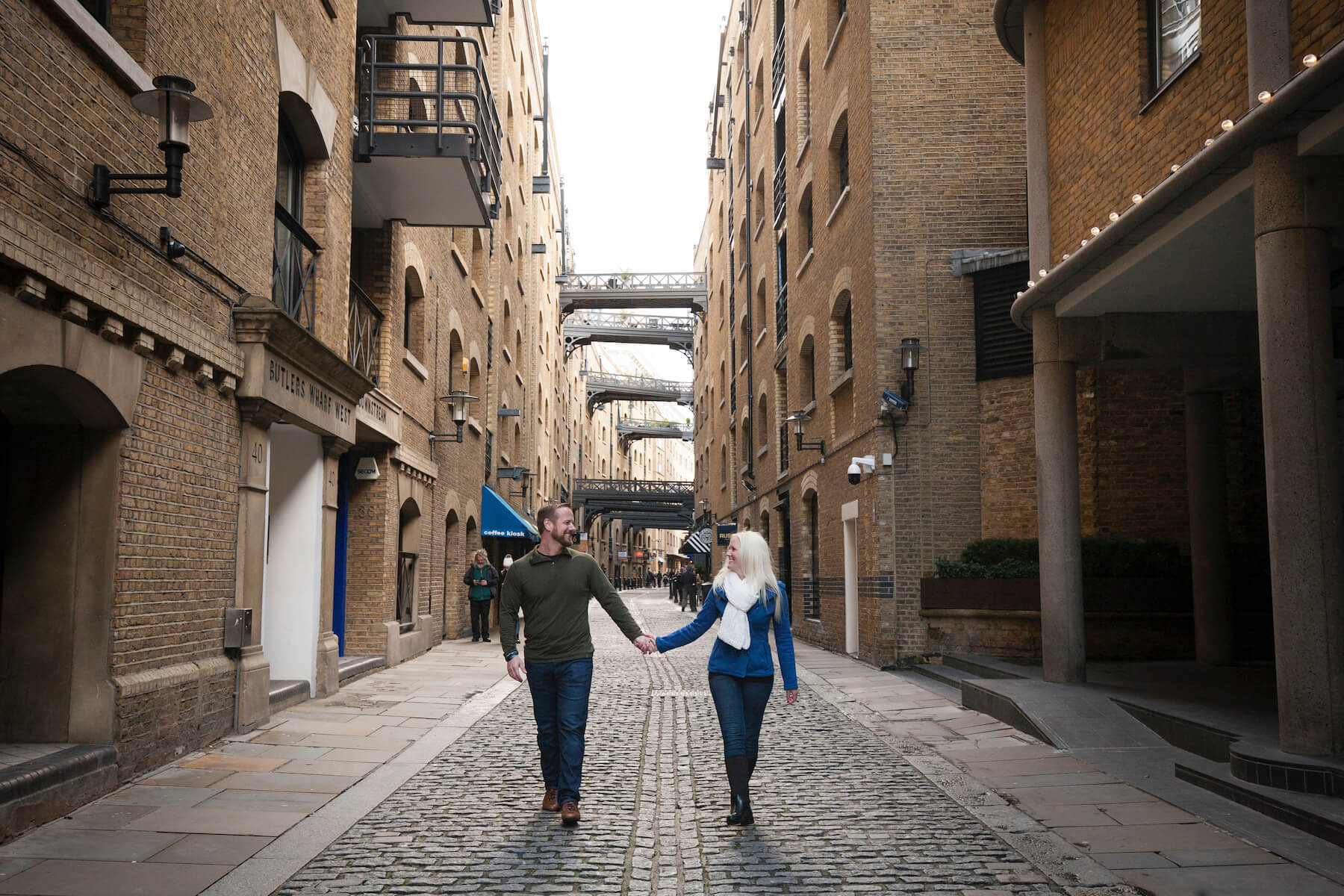 Couple holding hands and walking in London, England