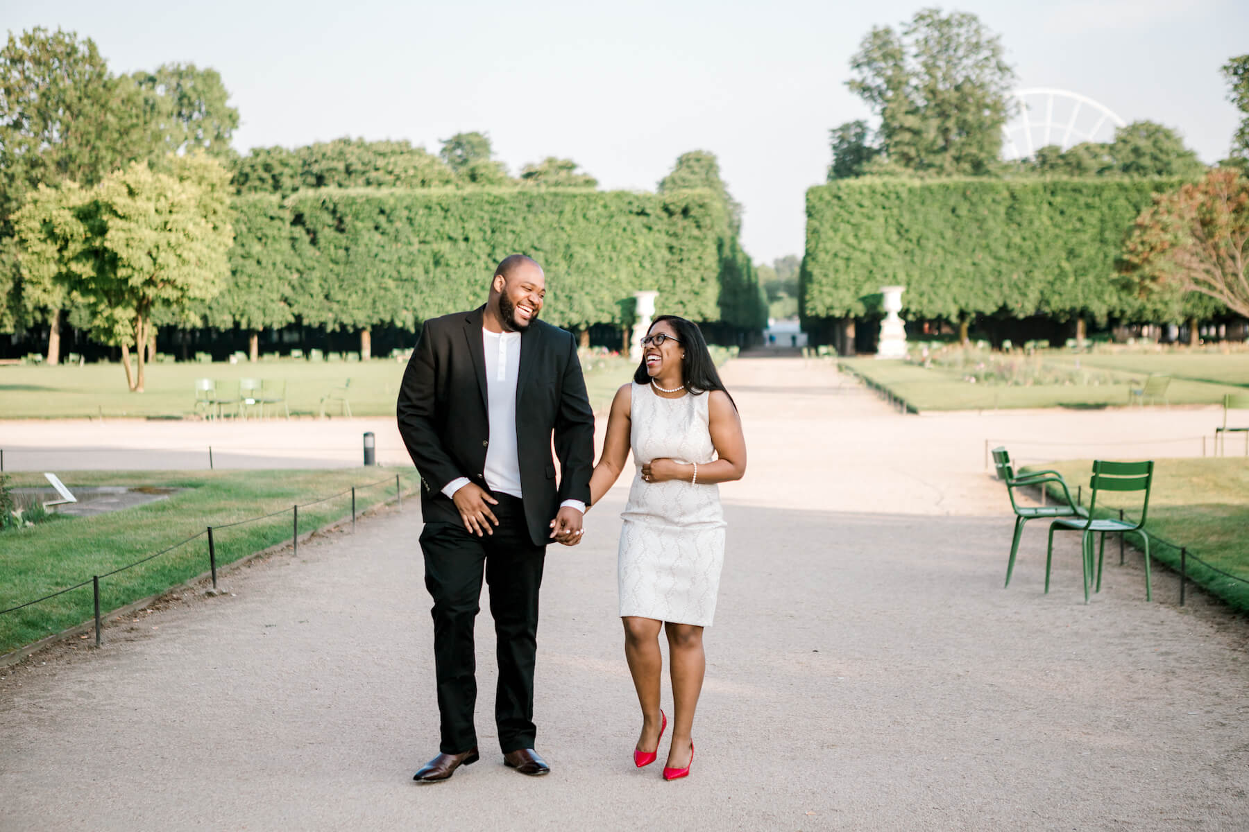 Couple holding hands and walking in a park in the Tuileries Garden in Paris, France