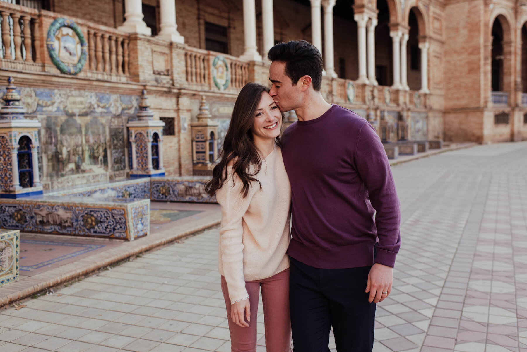 Couple walking in the city square in Seville, Spain