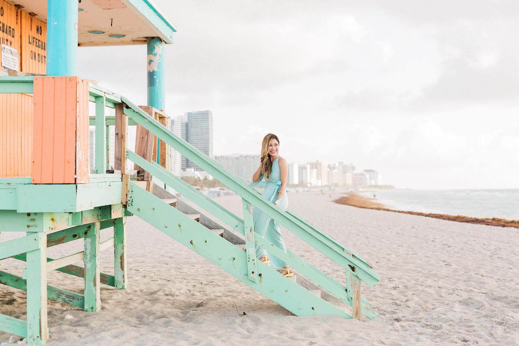 Solo traveller standing on a lifeguard station ramp on the beach in Miami, Florida