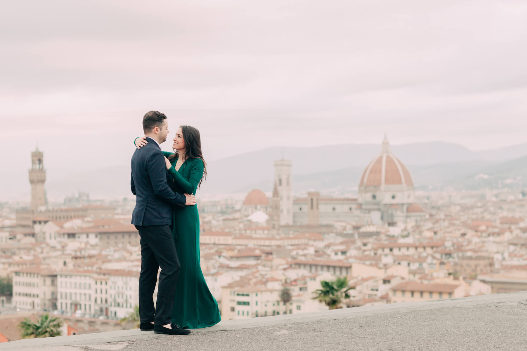 couple hugging with the city of Florence, Italy in the background