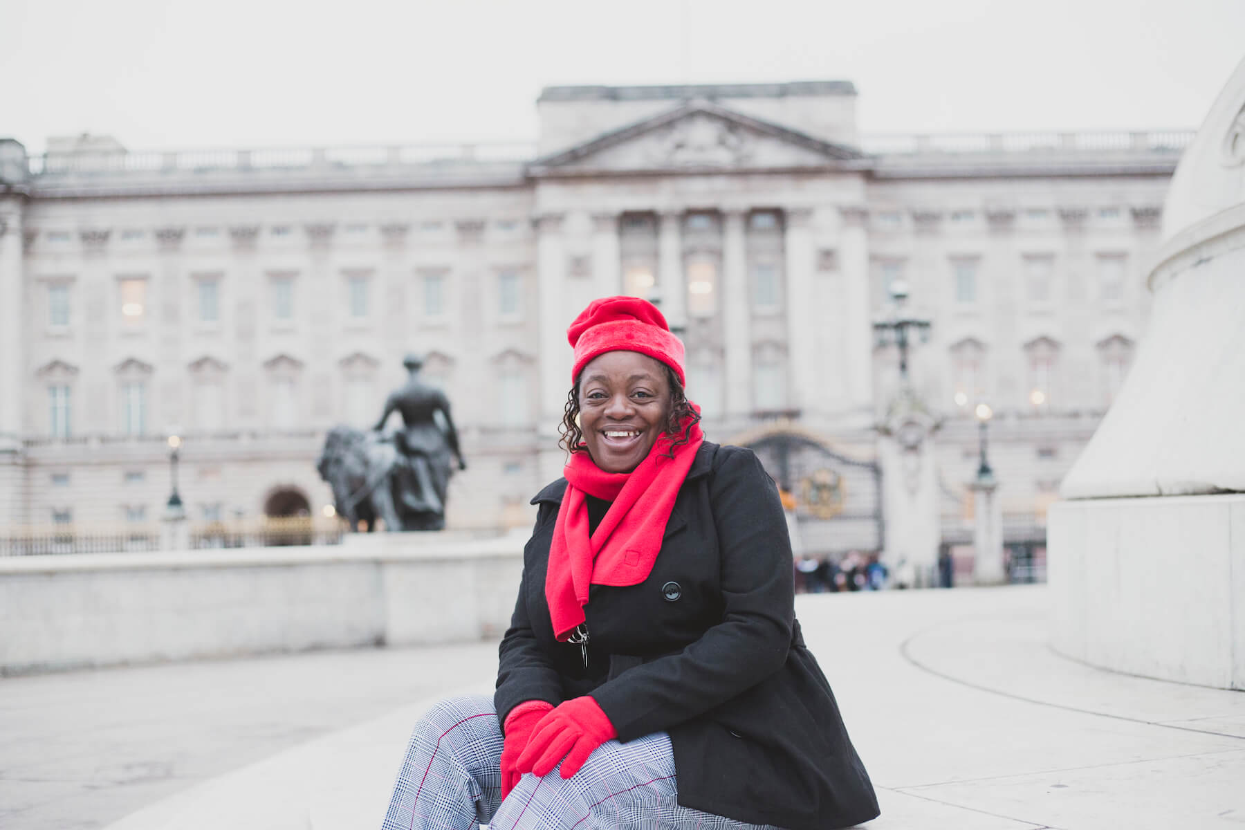 solo traveller sitting and smiling in London, England
