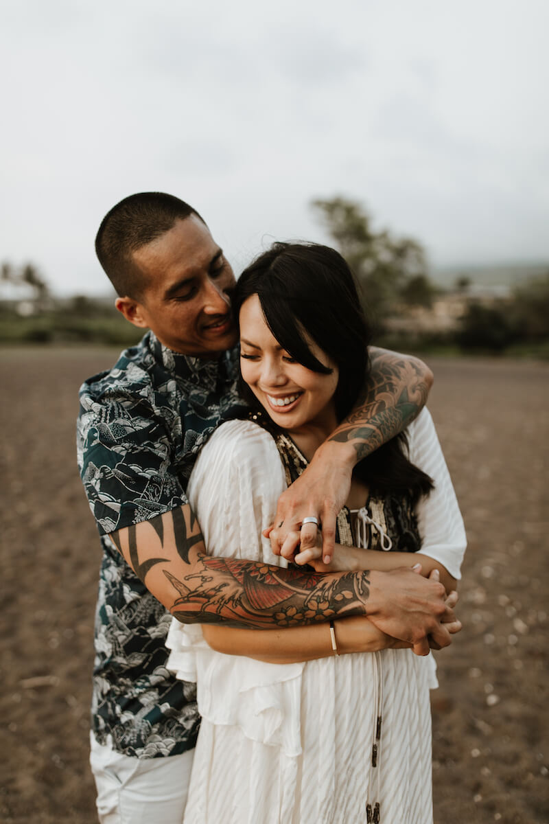 couple holding on the beach each other in Maui, Hawaii