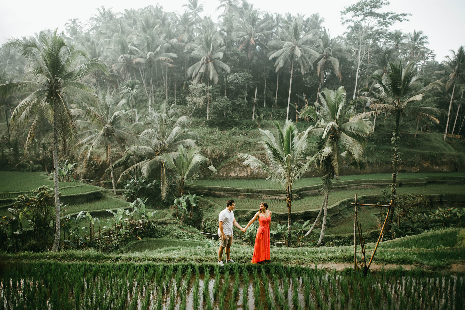 couple walking and holding hands in bali, Indonesia