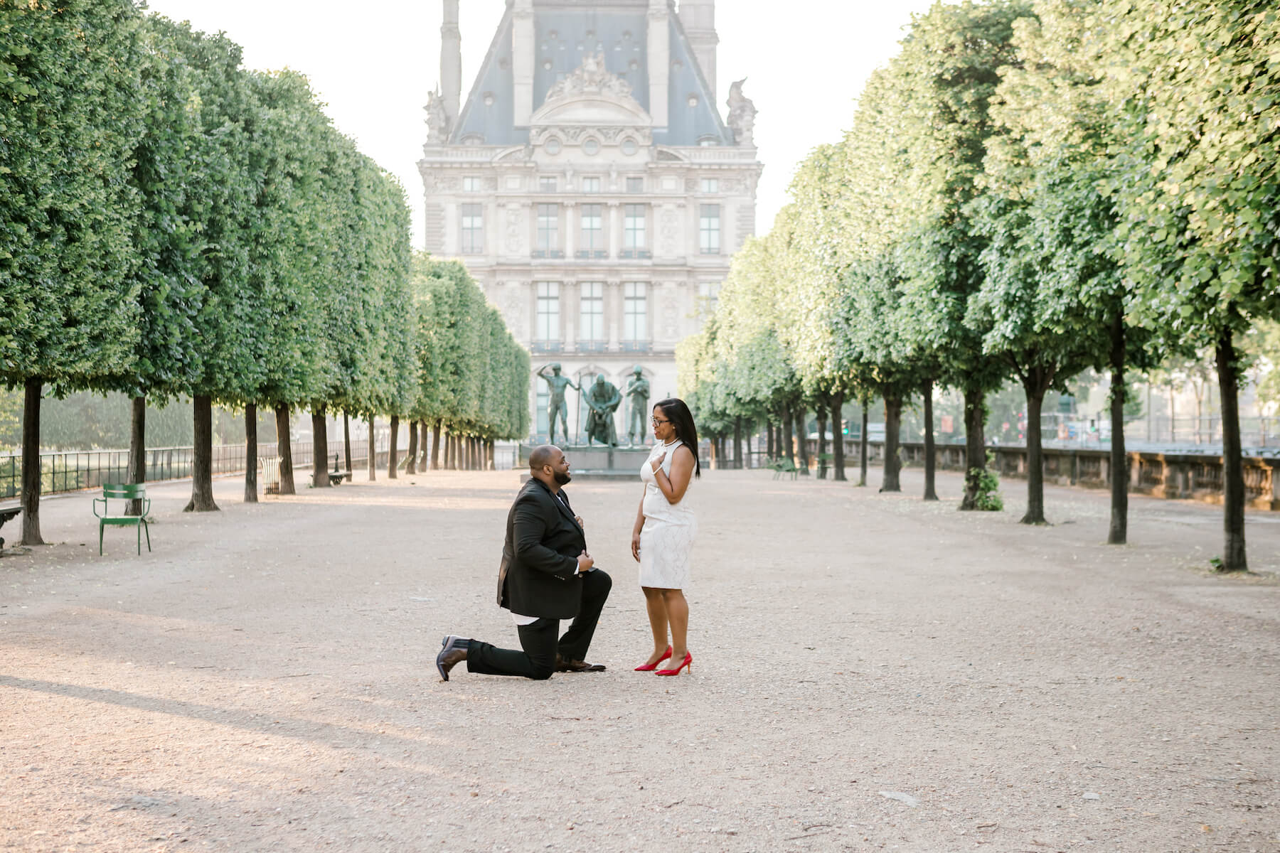 A man proposing on the Louvre grounds, in Paris, France 
