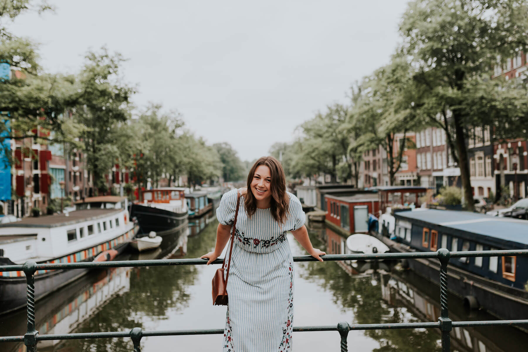 Solo woman traveler on a bridge in Amsterdam, Netherlands