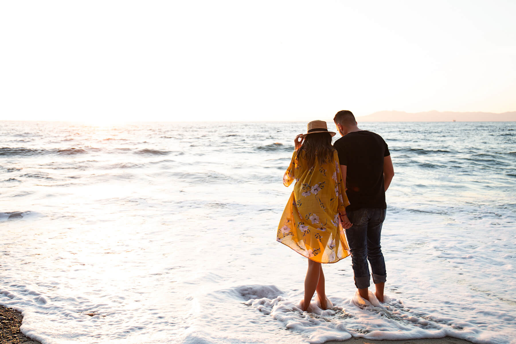Couple watching the sunset on the beach in Puerto Vallarta, Mexico