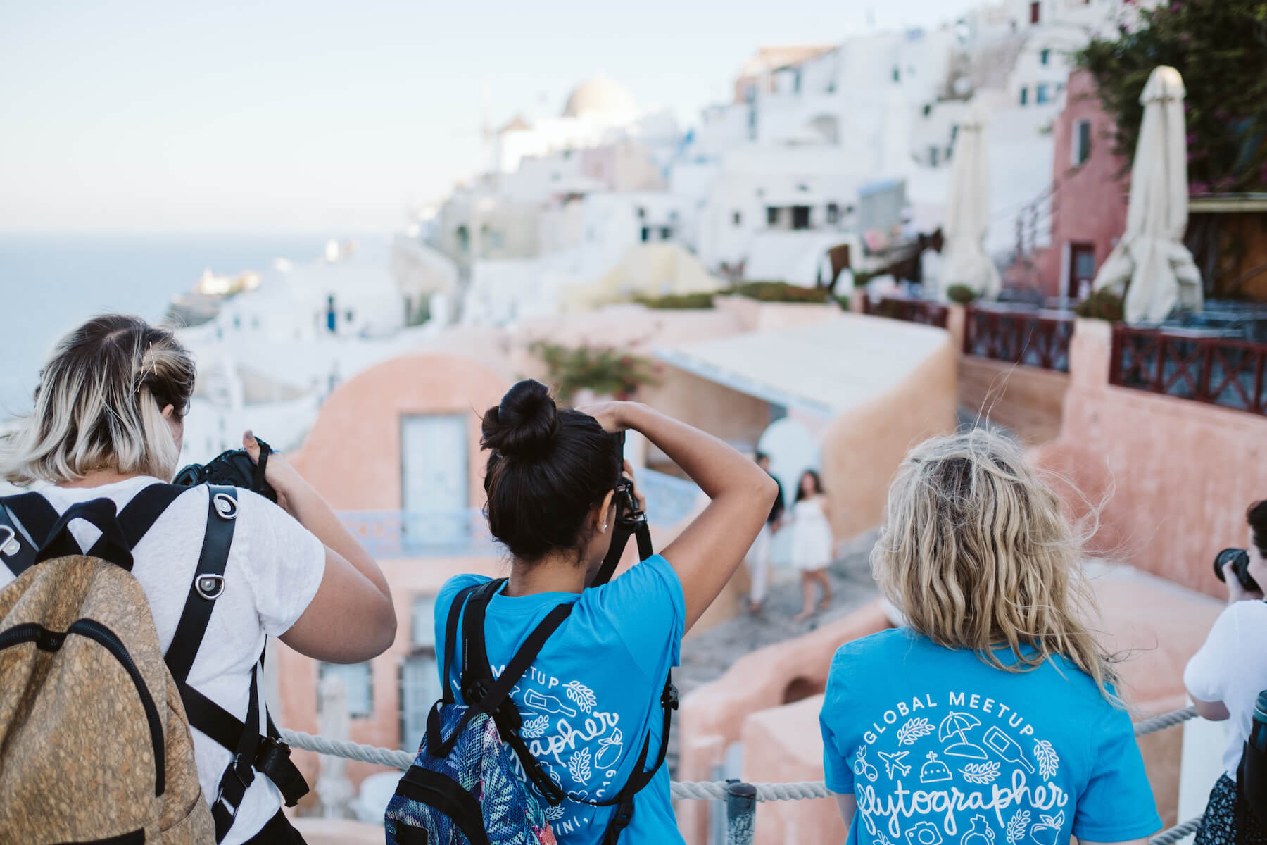 Photographers taking a photo of a couple in Santorini, Greece