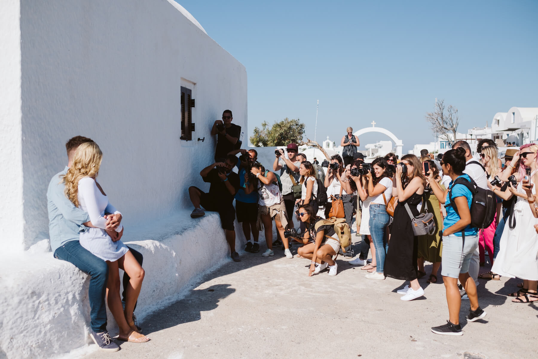 Group of photographer posing a couple in Santorini, Greece.