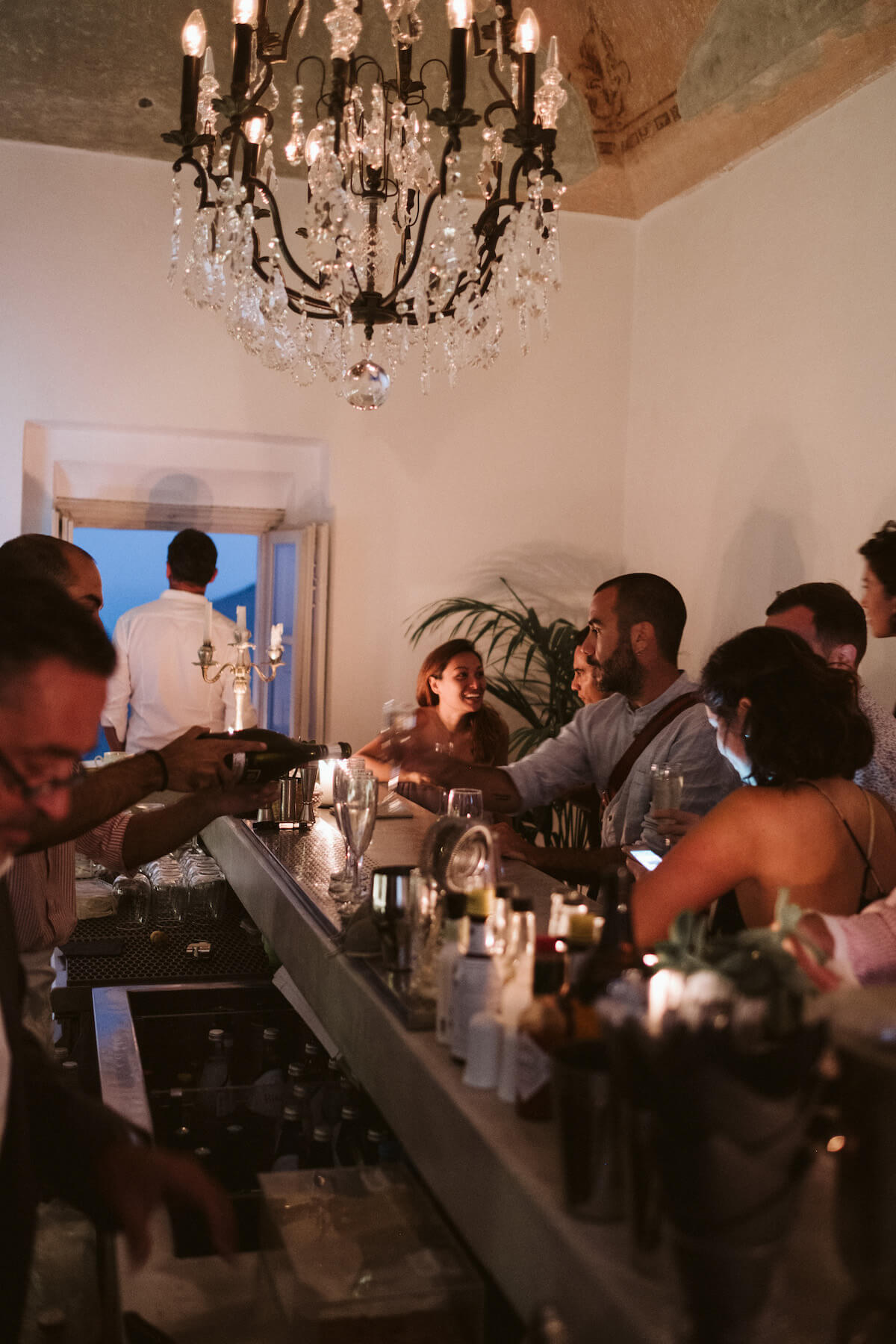 People standing at a bar in Santorini, Greece