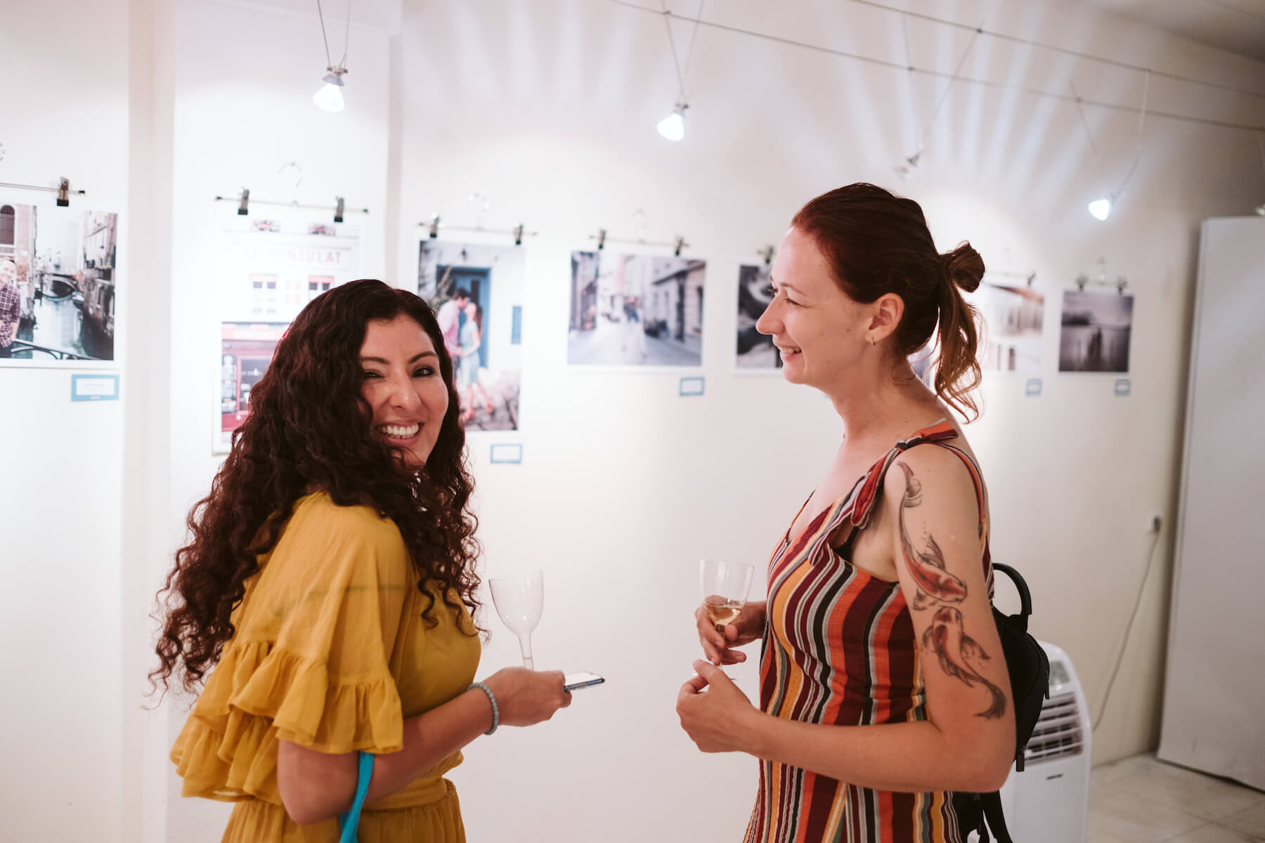Two woman talking in an art gallery in Santorini, Greece
