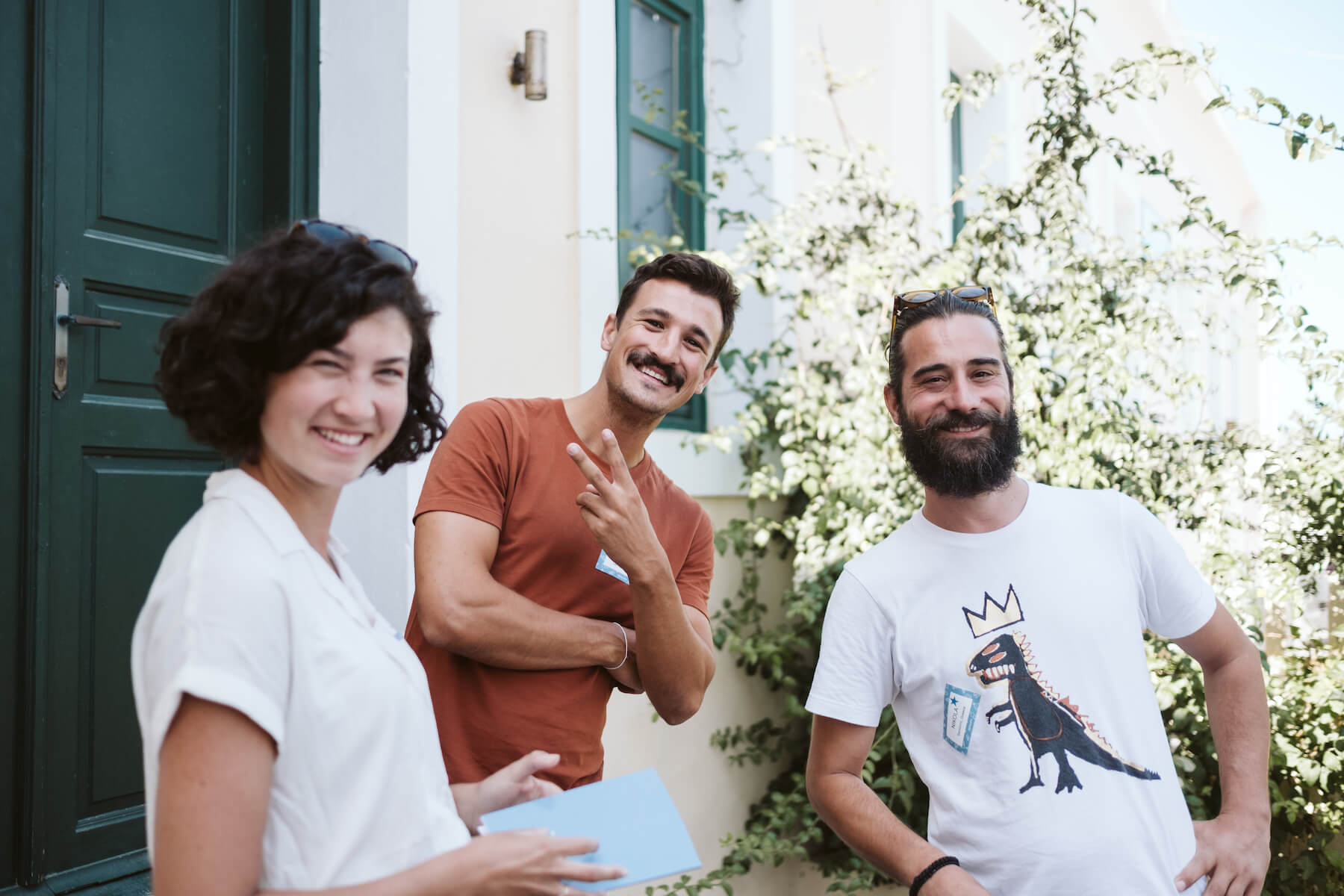 Three people smiling together in Santorini, Greece