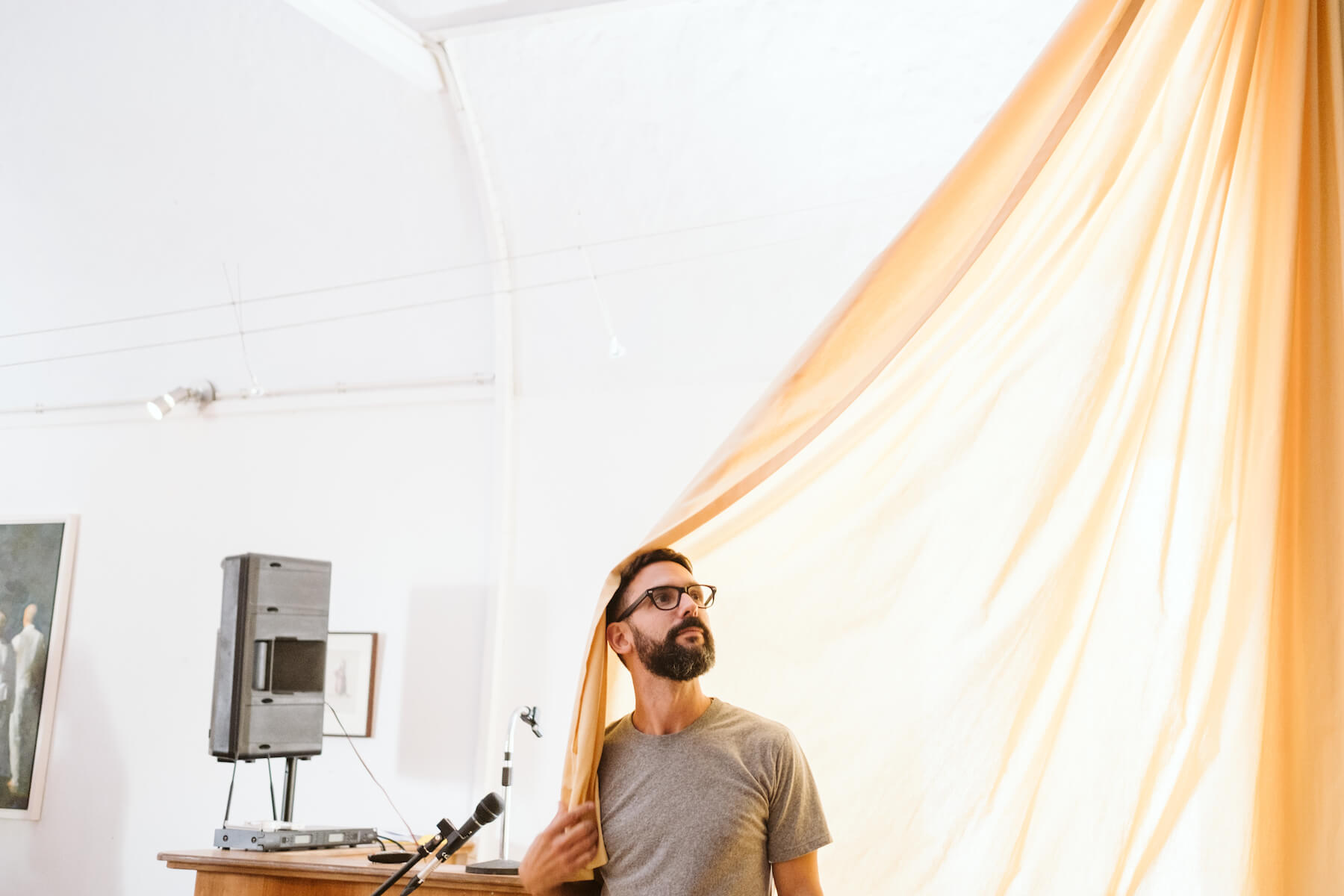 Man standing with a curtain in a conference room in Santorini, Greece