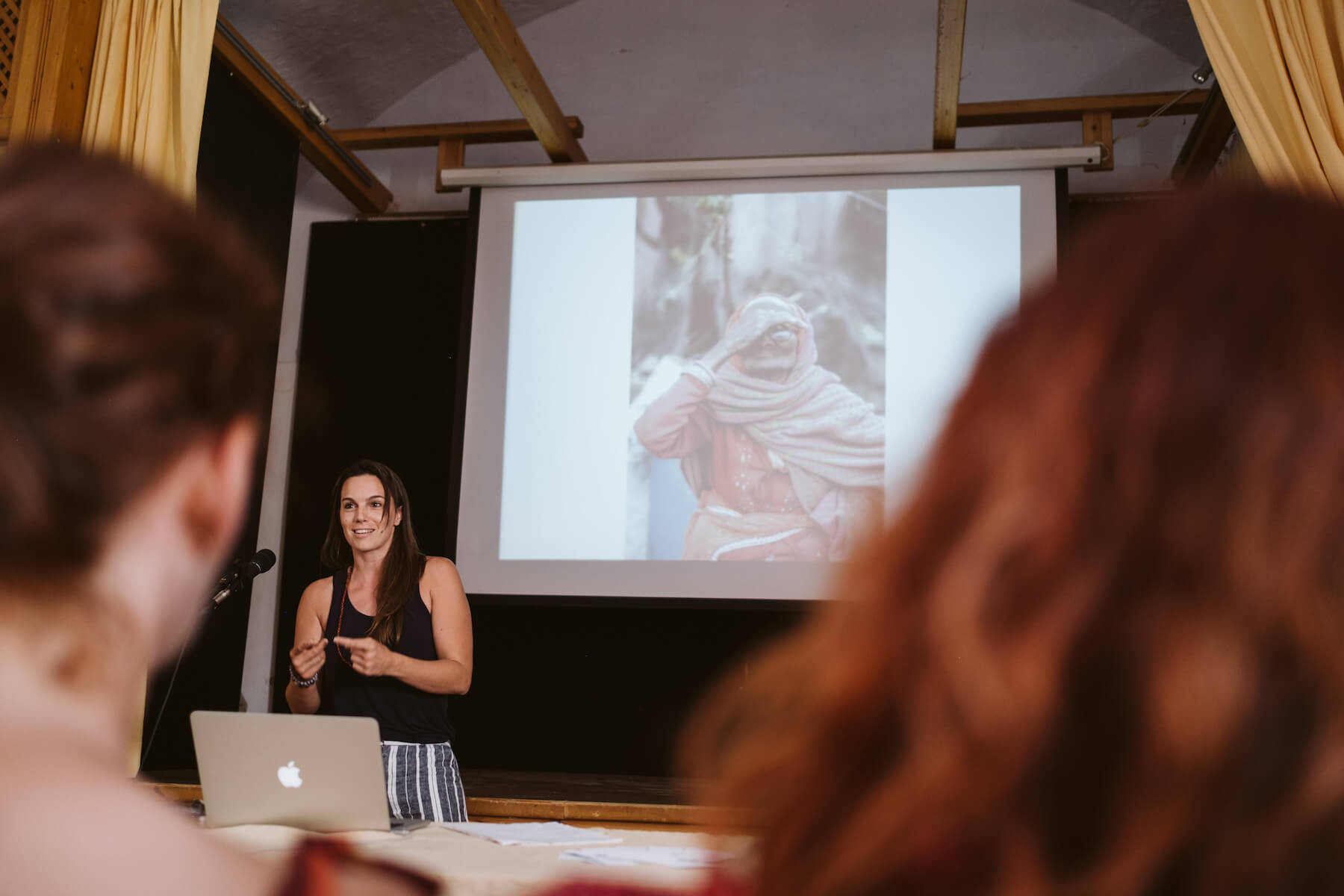 Woman presenting to a group in a conference room in Santorini, Greece