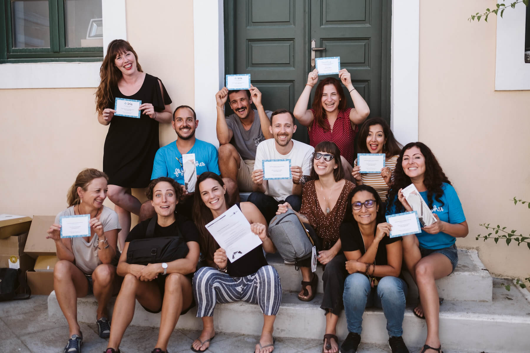 People holding up prizes in a courtyard in Santorini, Greece