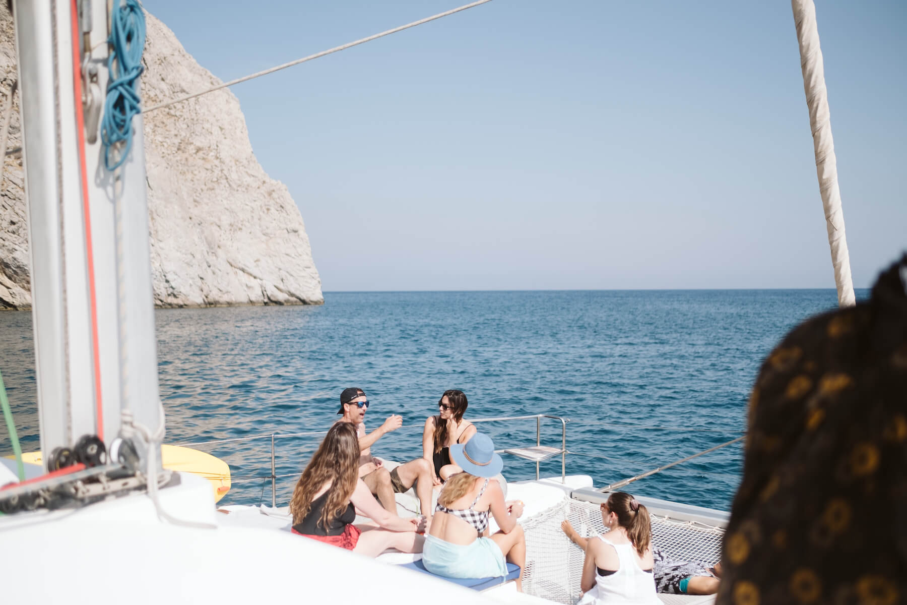 People talking on a catamaran in Santorini, Greece