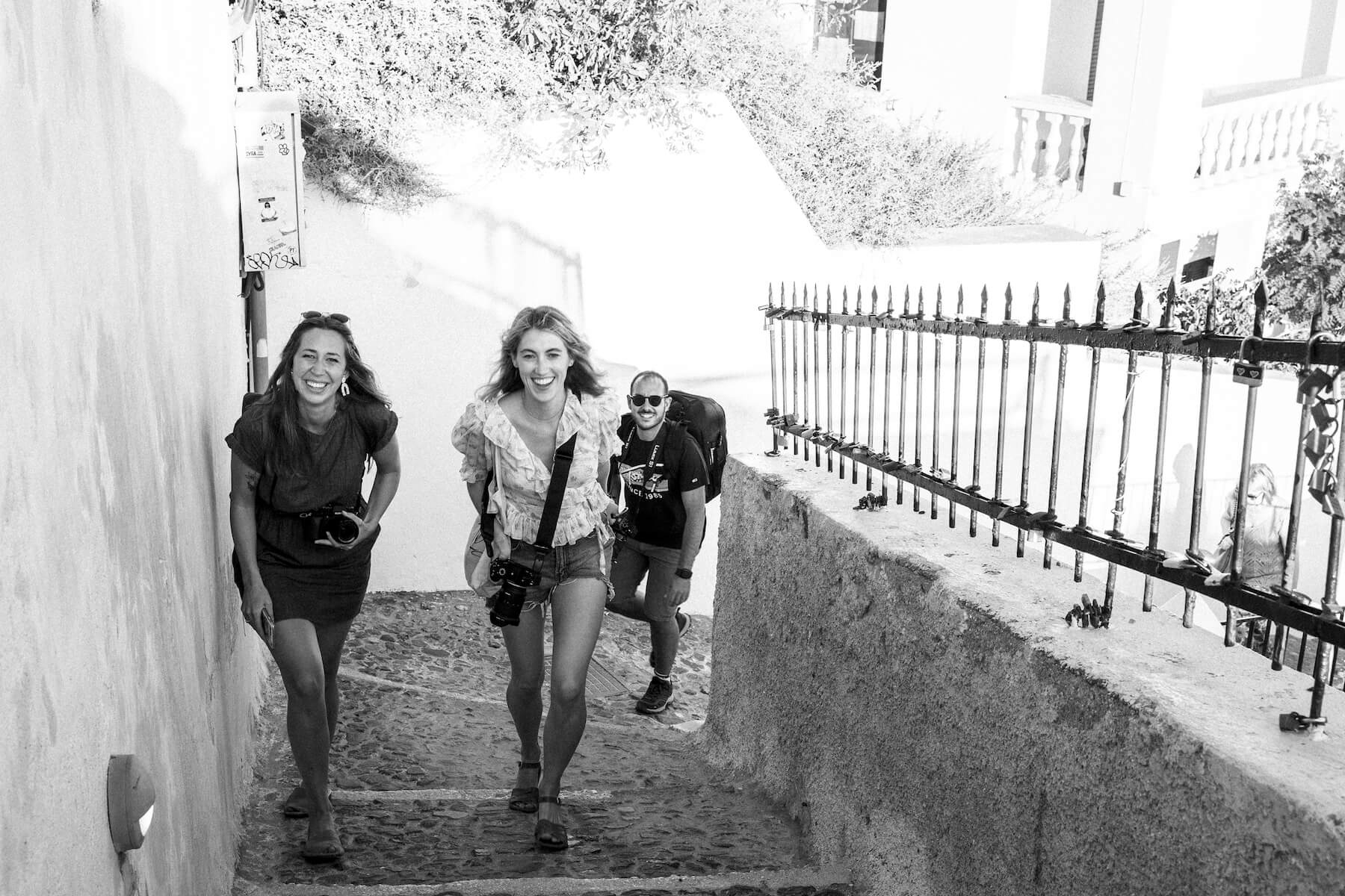 Photographers smiling and walking in Santorini, Greece
