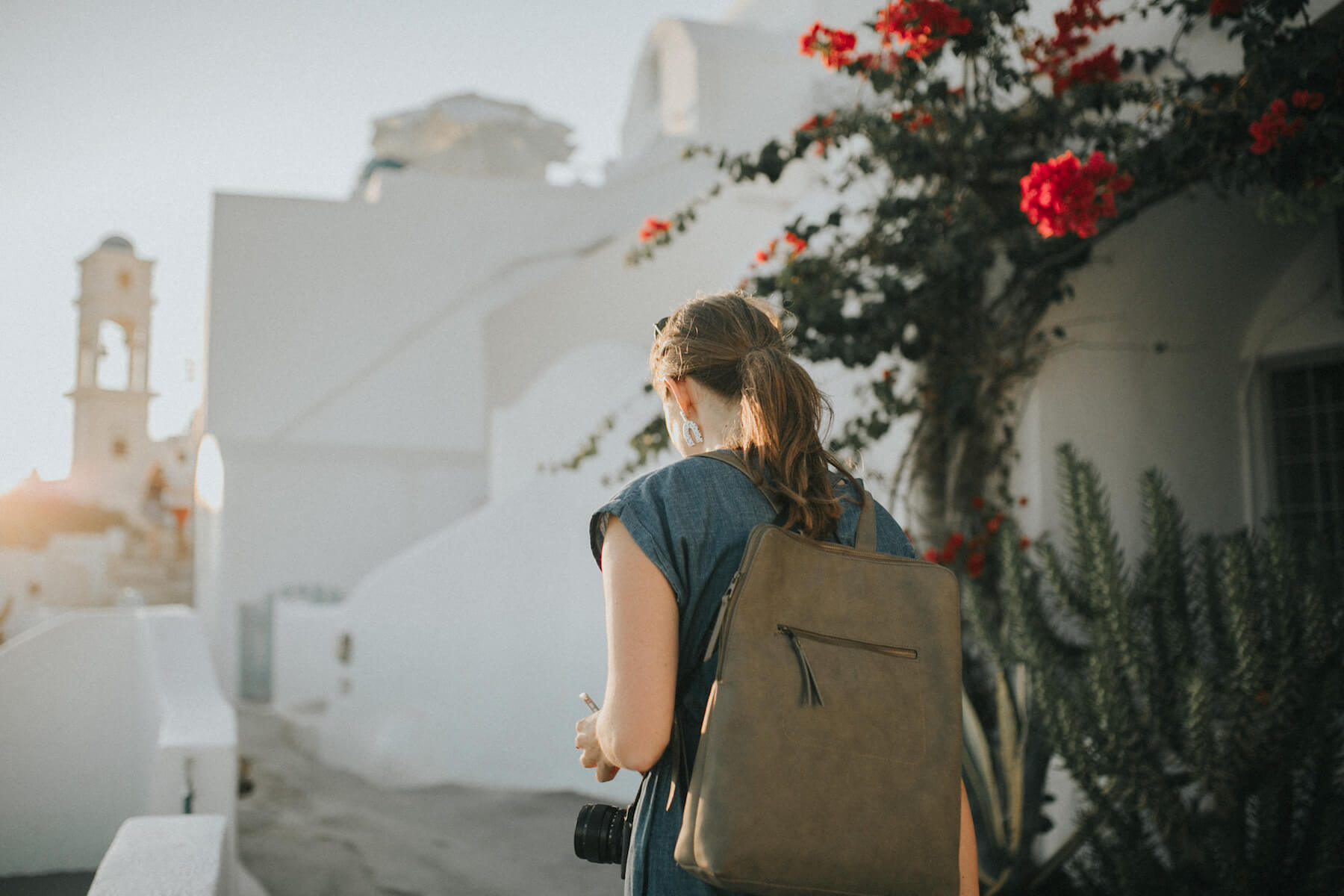 Photographer looking at camera while walking in Santorini, Greece