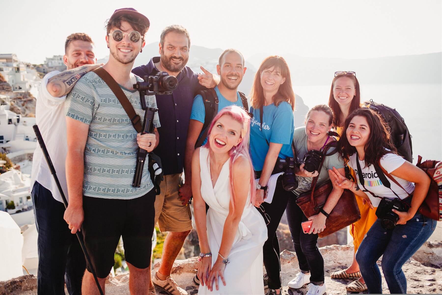 Group of people smiling and laughing in Santorini, Greece.