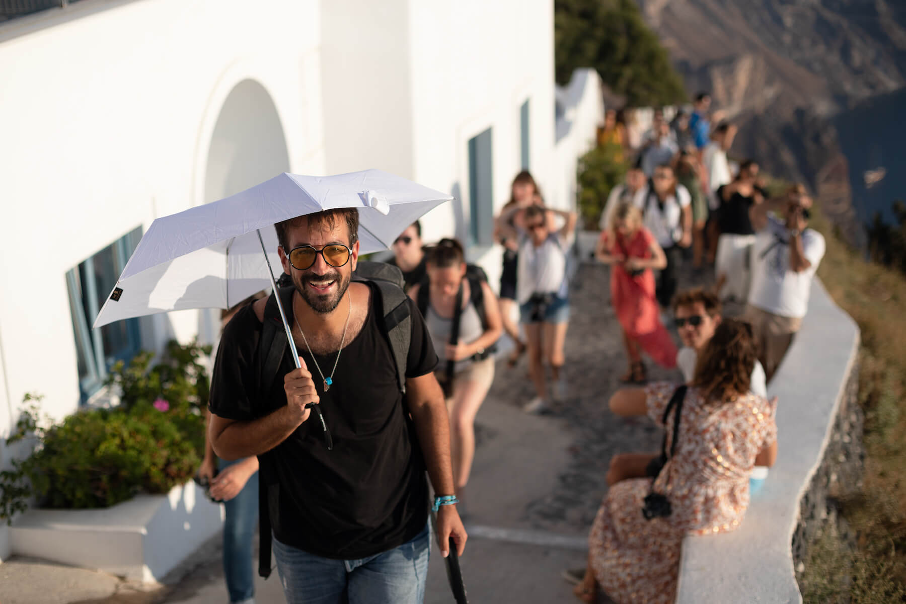 People hiking on a trail in Santorini, Greece