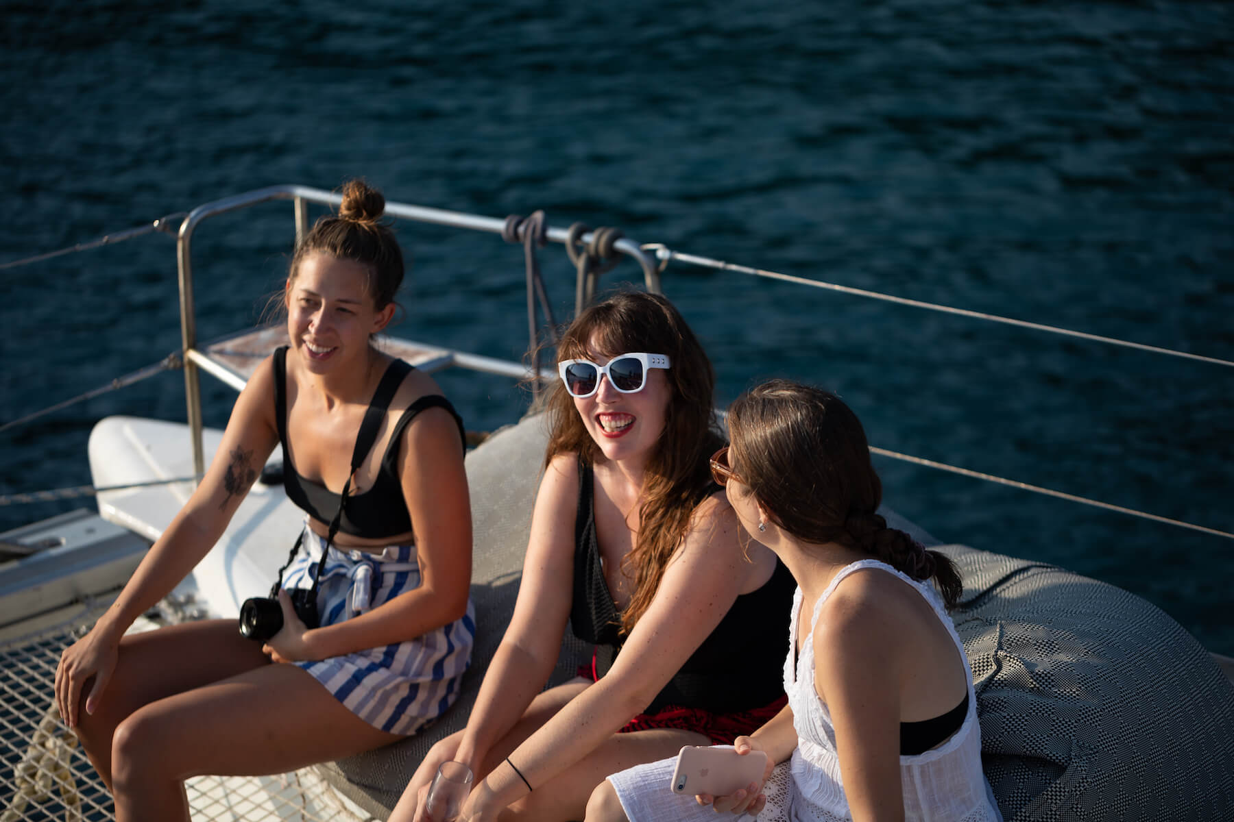 Women talking on a boat in Santorini, Greece