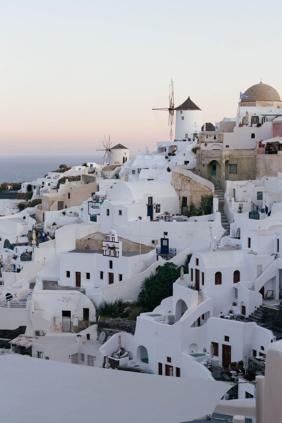 Windmill and houses at sunrise in Santorini, Greece.