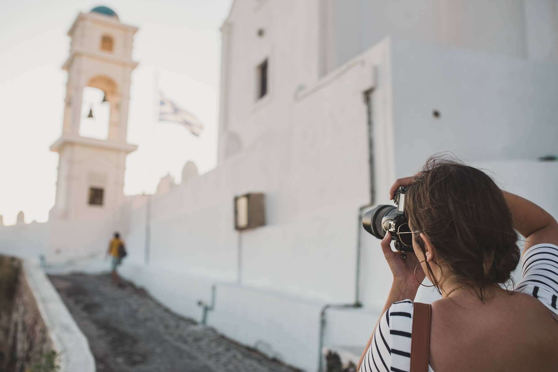 Photographer shooting a scene in Santorini, Greece