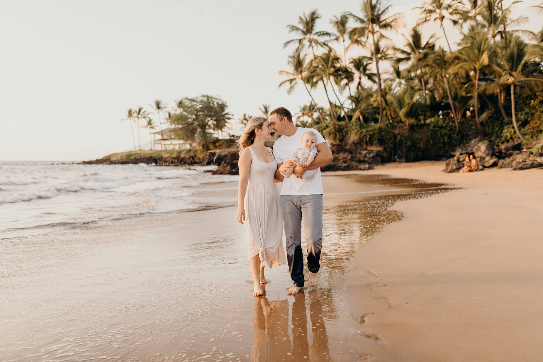 family with a baby having fun on the beach in Maui, Hawaii