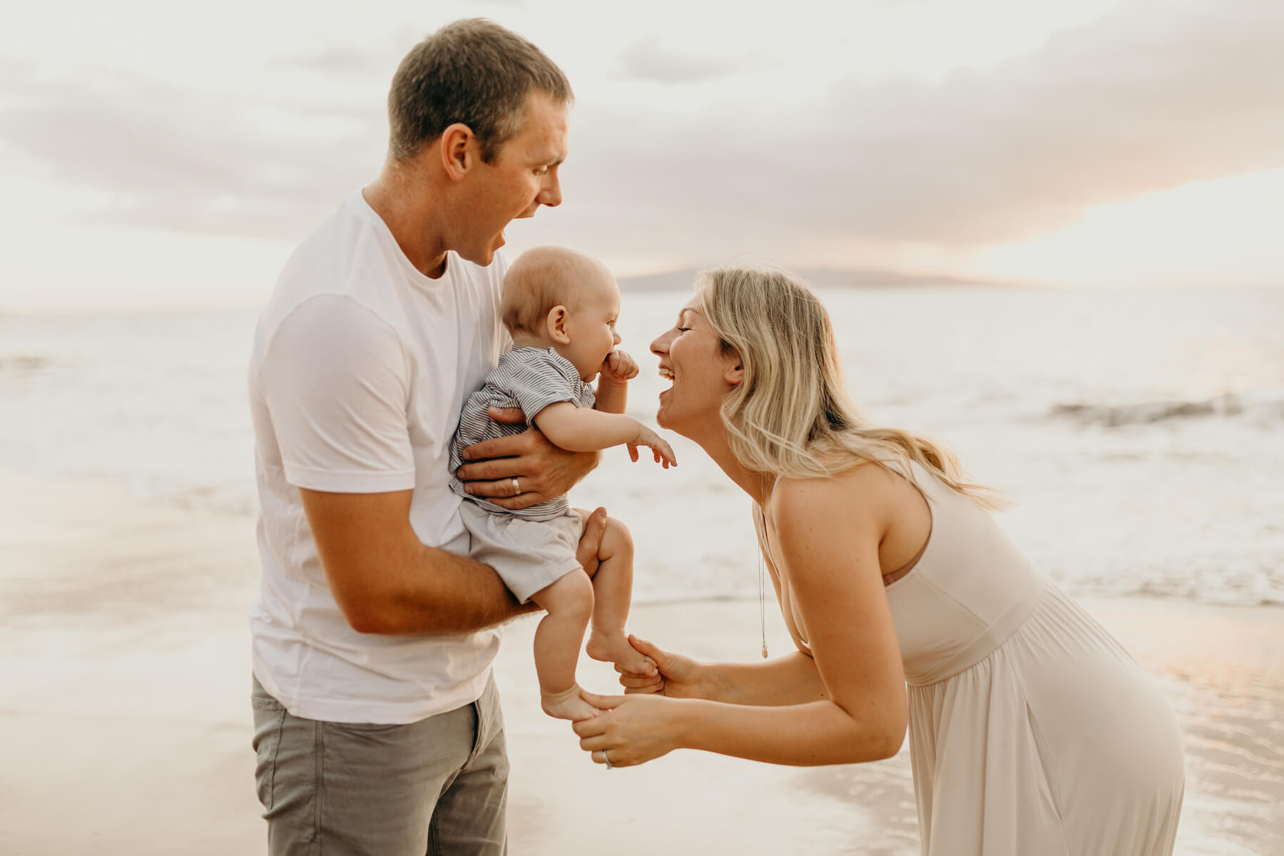 family with a baby having fun on the beach in Maui, Hawaii