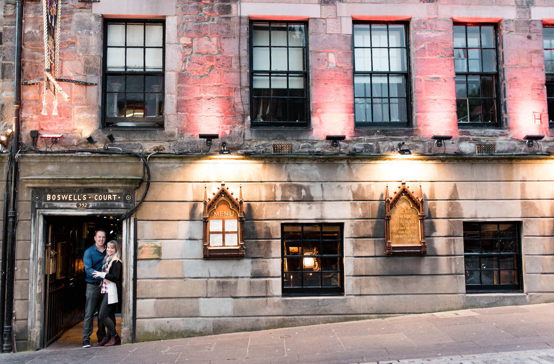 couple standing in the doorway of a pub in Edinburgh, Scottland
