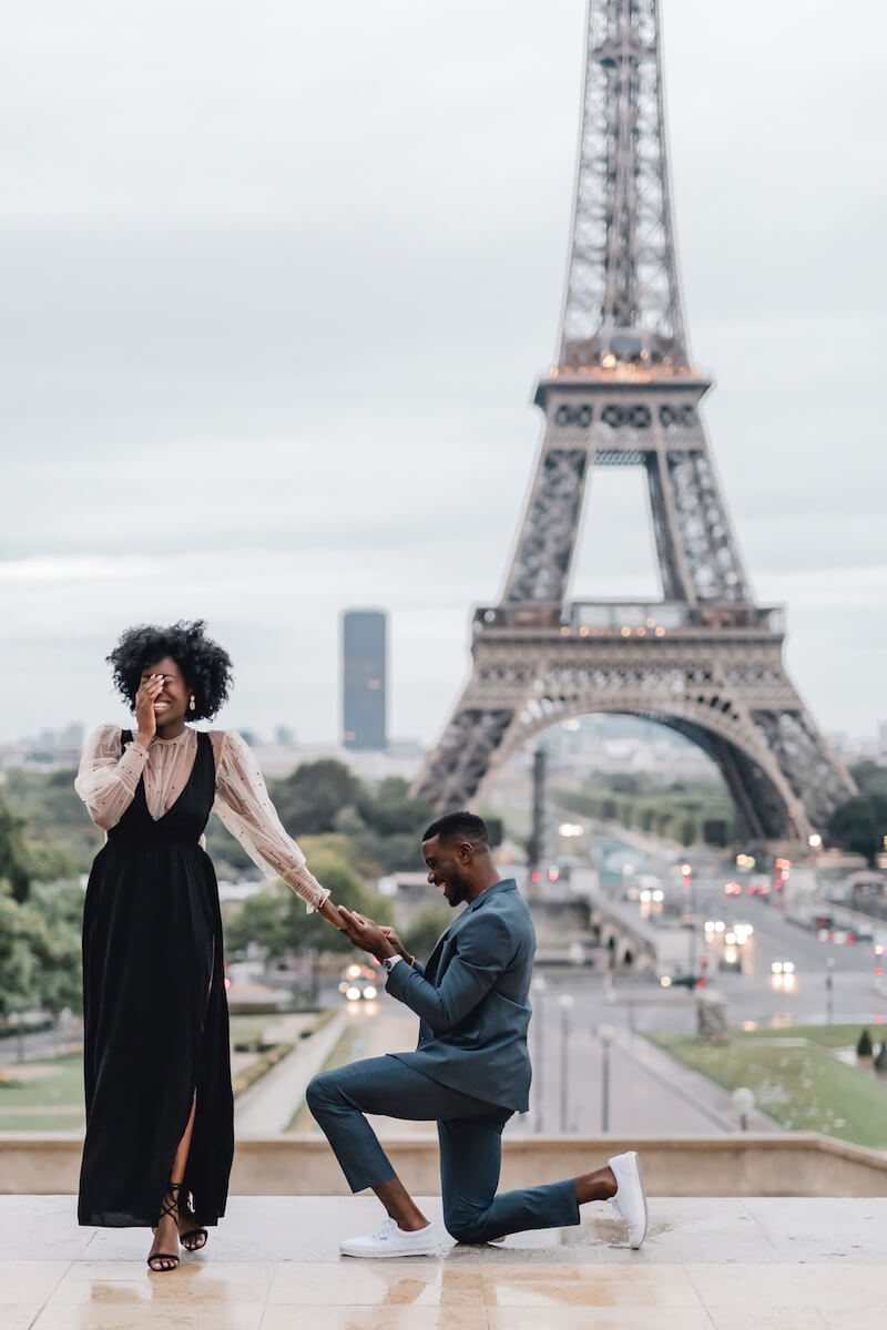 a woman is being proposed to in front of the Eiffel Tower in Paris, France
