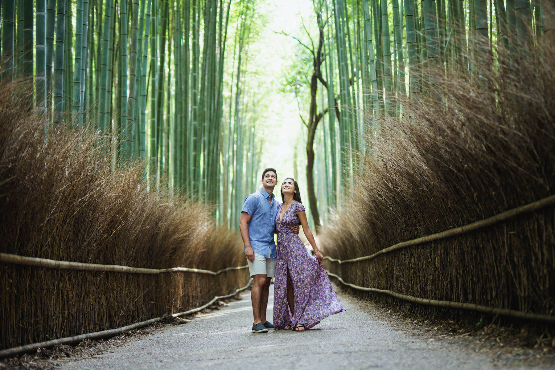 couple walking in bamboo forest in Kyoto, Japan