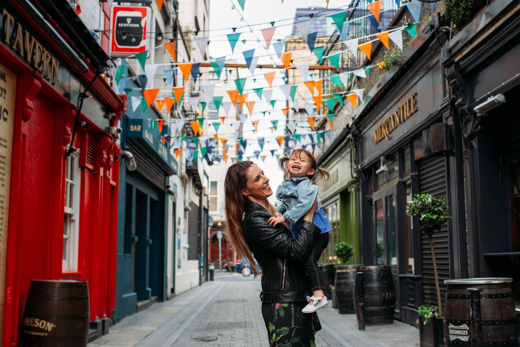 a mother and daughter standing on a colorful street in Dublin, Ireland