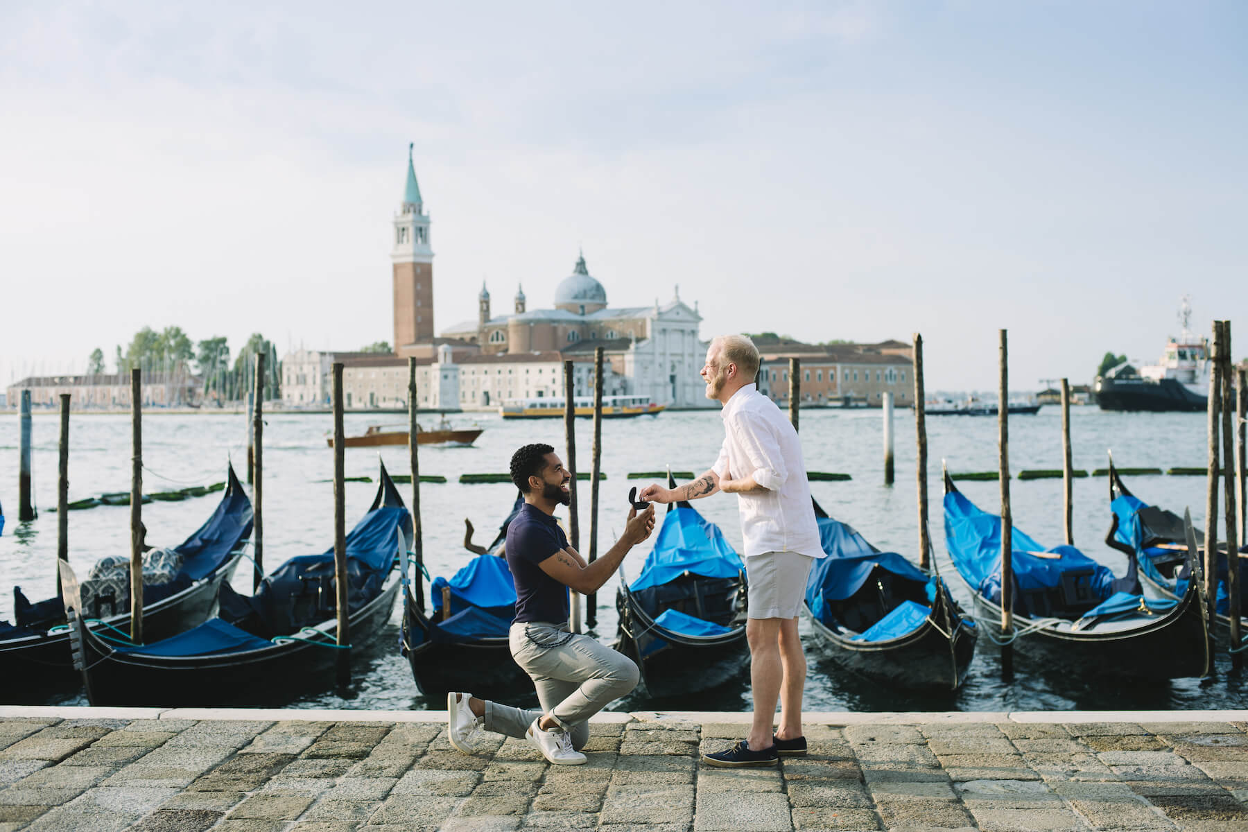 LGBTQ couple, and one man is proposing to the other in Venice, Italy