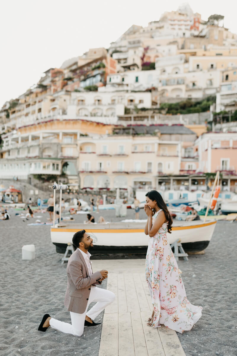 couple in Positano, the man is proposing to the woman on the beach in Positano, Italy