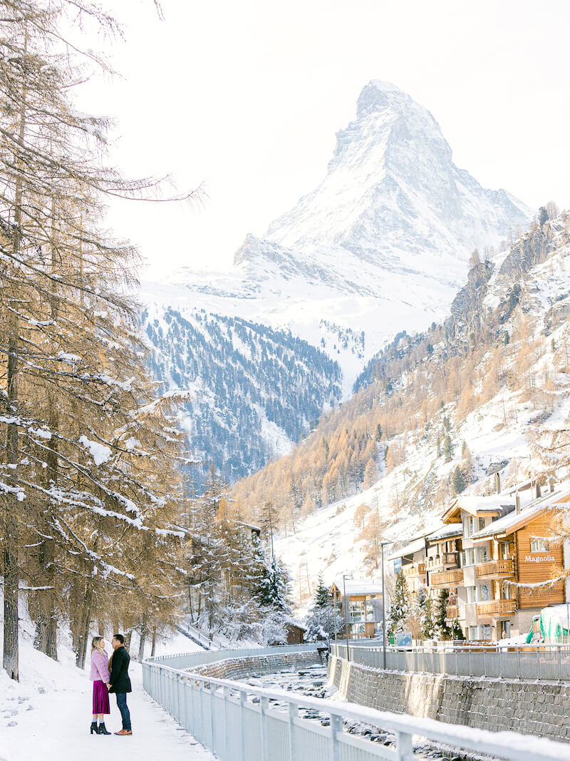 couple looking at each other and holding hands in a mountainside village in Zermatt, Switzerland