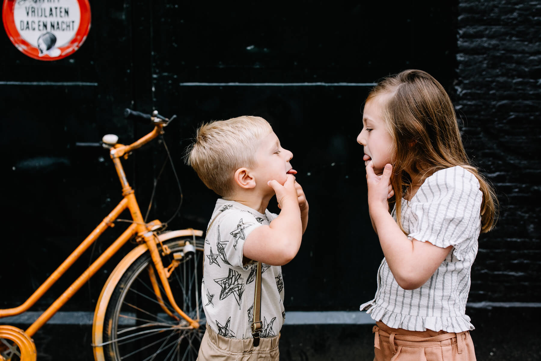 kids having fun, sticking their tongues out in Amsterdam, Netherlands