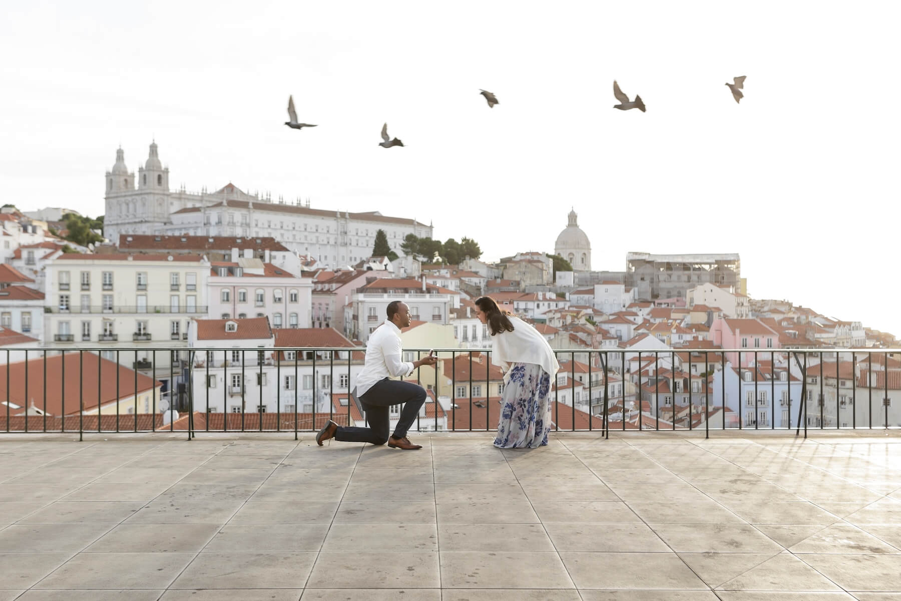 a man is proposing to a woman in Lisbon, Portugal 