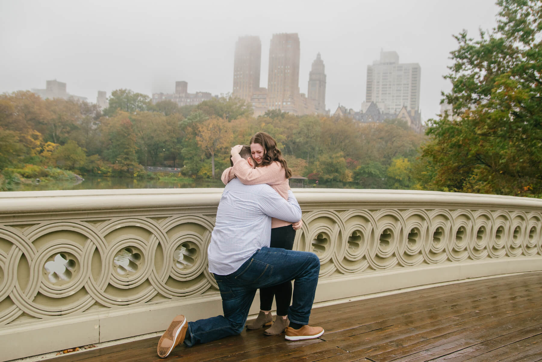 couple hugging each other with NYC in the background, the man just proposed to the woman in NYC, New York
